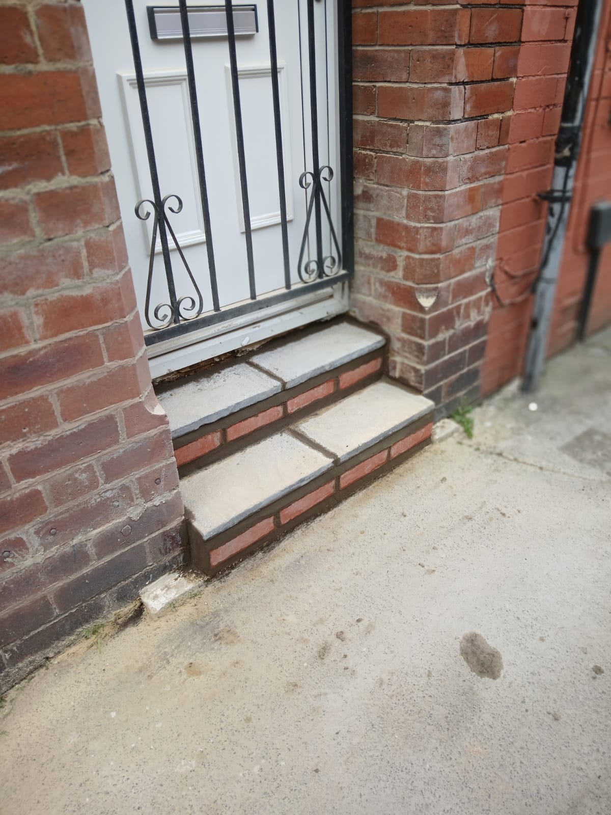 Rebuilt brick front steps with neat pointing and clean stone treads