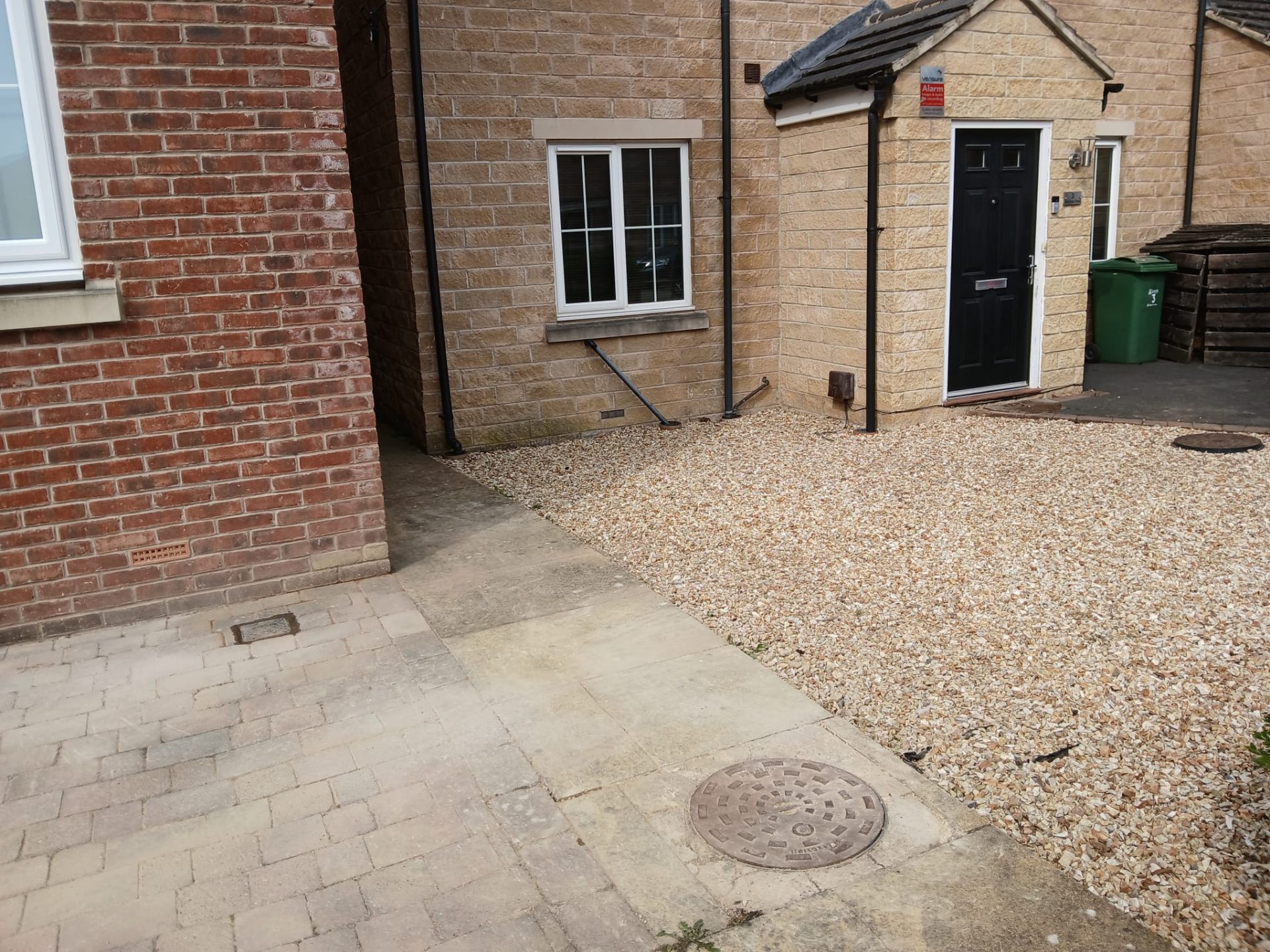 Completed driveway and gravel area with reinstated drainage covers