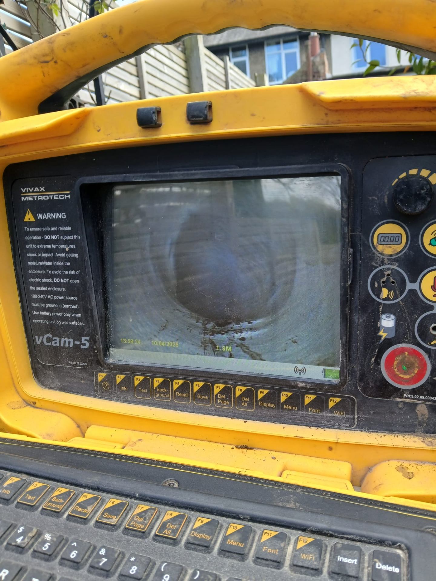 Vivax vCam-5 CCTV drain survey monitor showing inside of a drainage pipe at 1.8m